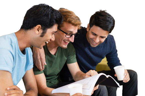 three-fellow-students-reading-textbook-laughing